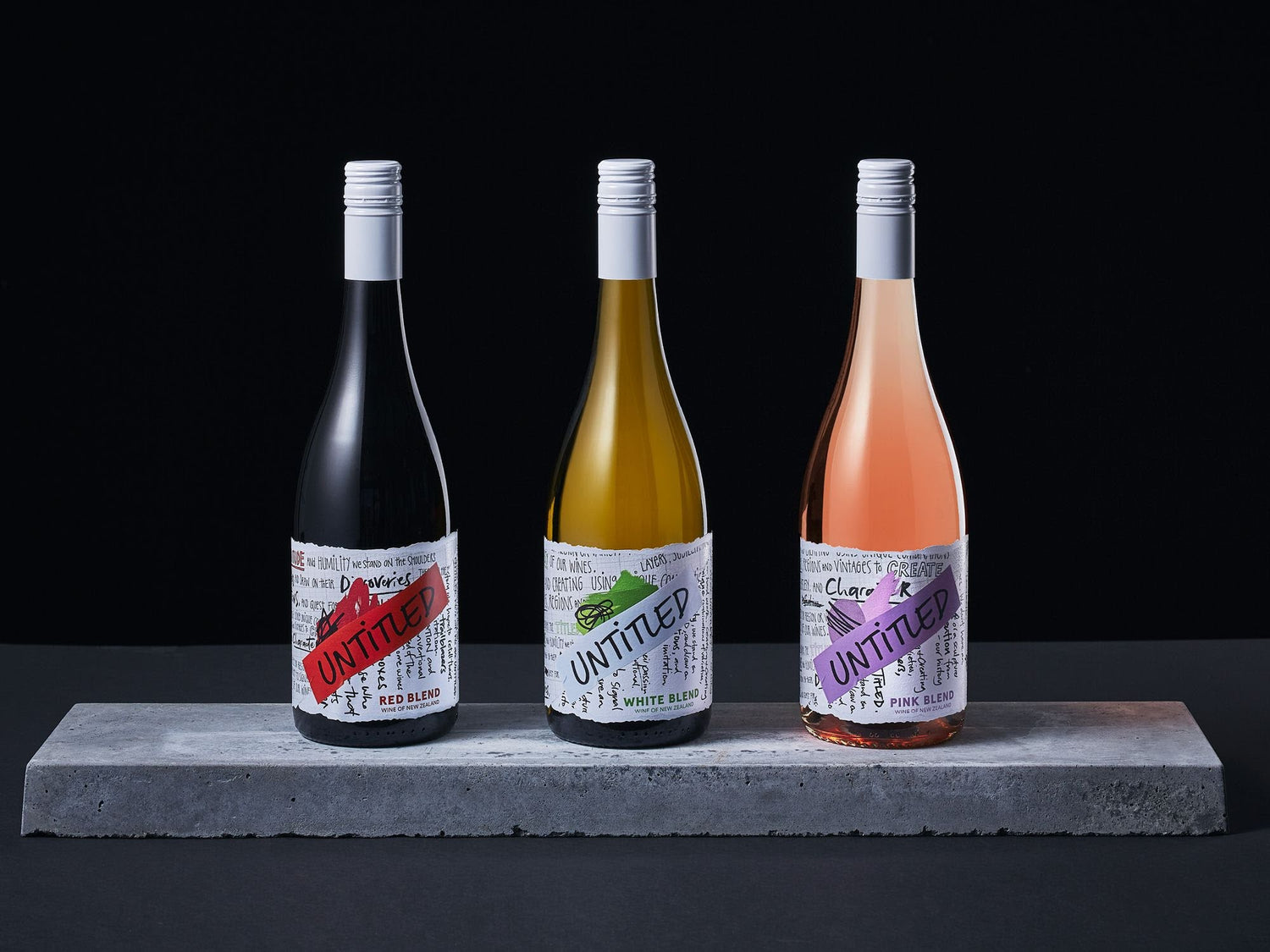 Untitled Wines Red Blend, White Blend and Pink Blend bottles on a concrete plinth, boutique New Zealand wines